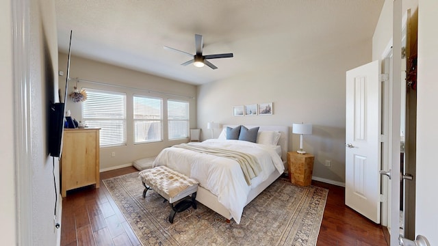 bedroom featuring dark wood-style floors, baseboards, and a ceiling fan