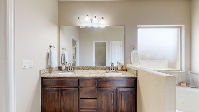 full bathroom featuring double vanity, a sink, and a whirlpool tub