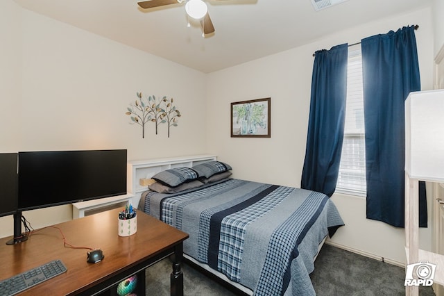 carpeted bedroom with a ceiling fan and visible vents