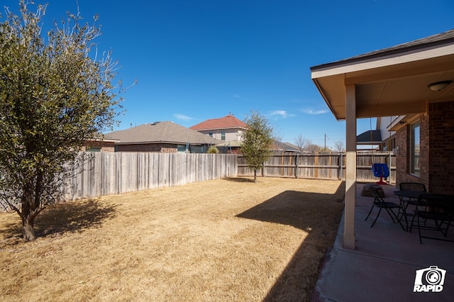 view of yard featuring a patio area and a fenced backyard