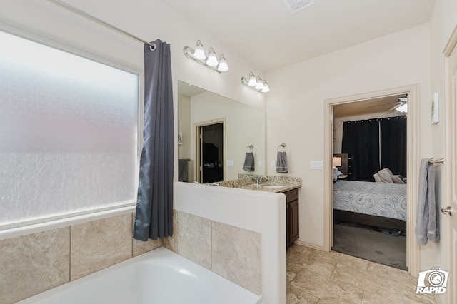 full bath featuring ensuite bathroom, visible vents, a sink, and a bathing tub