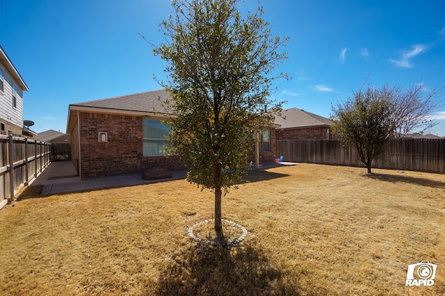 view of yard with a fenced backyard and a patio