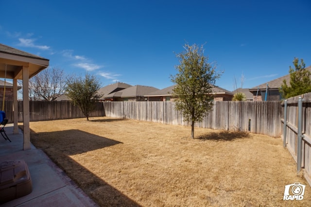 view of yard with a fenced backyard and a patio