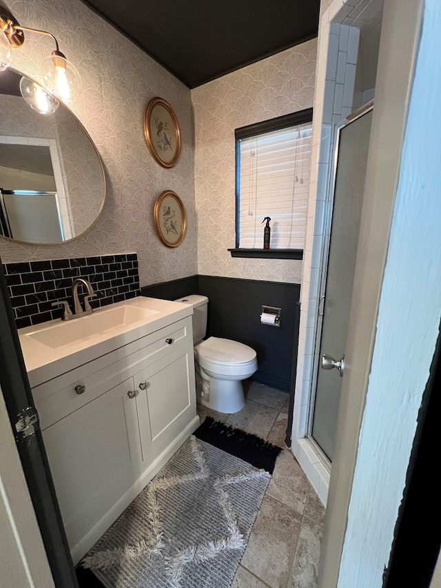 bathroom featuring toilet, vanity, and walk in shower