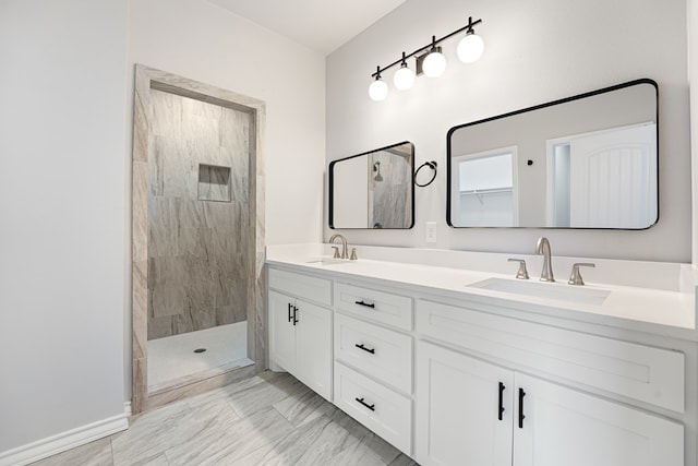 bathroom featuring a tile shower and vanity