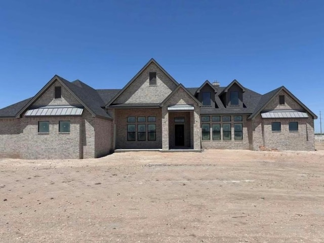 view of front of house featuring a standing seam roof and metal roof