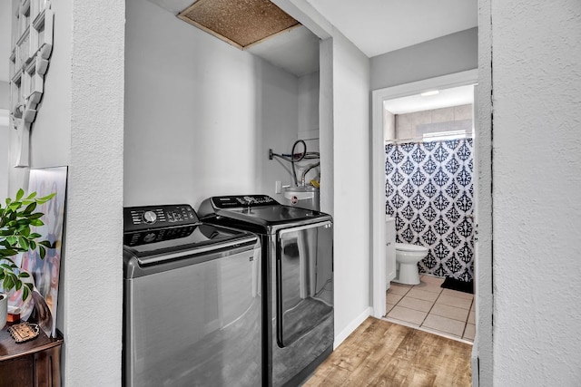 1105 Lamar Ave, Big Spring, TX 79720 - laundry room featuring attic access, washer and dryer, wood finished floors, laundry area, and water heater