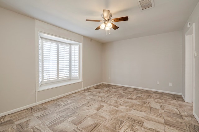 unfurnished room with ceiling fan