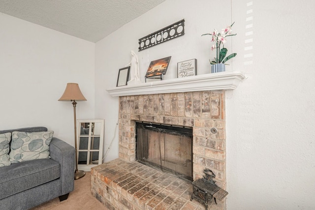 interior space featuring a brick fireplace and a textured ceiling