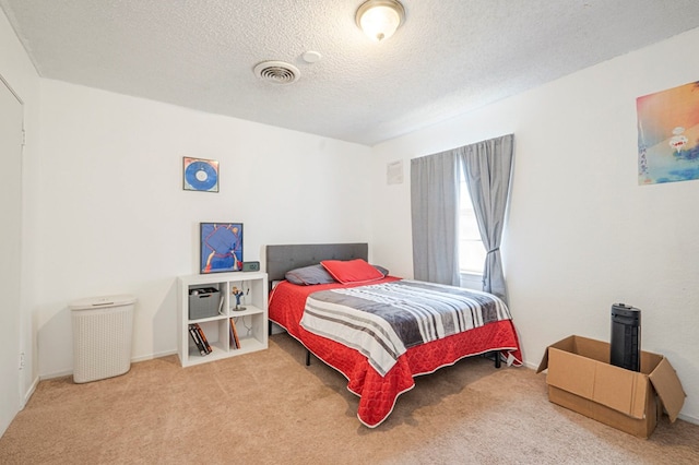 bedroom featuring carpet floors and a textured ceiling