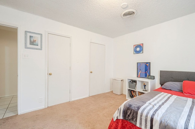 bedroom with a textured ceiling and carpet flooring