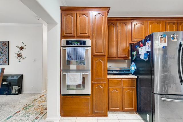 kitchen with ornamental molding, stainless steel appliances, and light tile patterned flooring