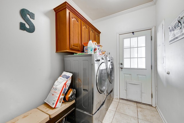 clothes washing area with crown molding, cabinets, light tile patterned floors, and independent washer and dryer