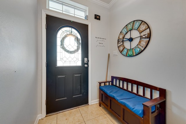 foyer featuring crown molding and light tile patterned floors