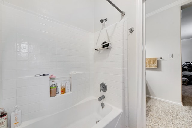 bathroom with tiled shower / bath combo and crown molding