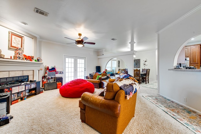 carpeted living room featuring french doors, ceiling fan, and ornamental molding