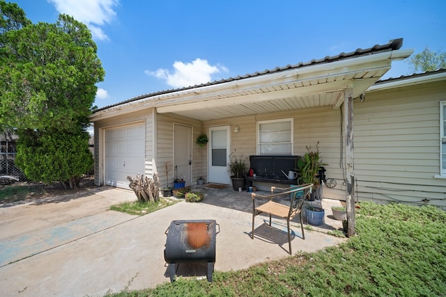 1213 Ridgeroad Dr, Big Spring, TX 79720 - view of patio featuring concrete driveway and an attached garage