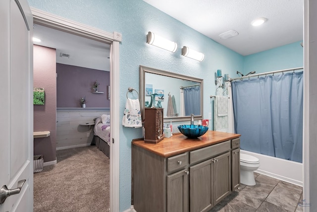 full bathroom featuring vanity, tile patterned flooring, toilet, a textured ceiling, and shower / tub combo with curtain