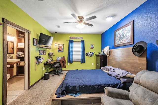 carpeted bedroom with ceiling fan and a textured ceiling