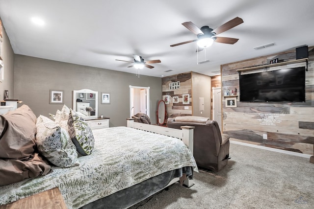 bedroom featuring ceiling fan, carpet floors, and wooden walls