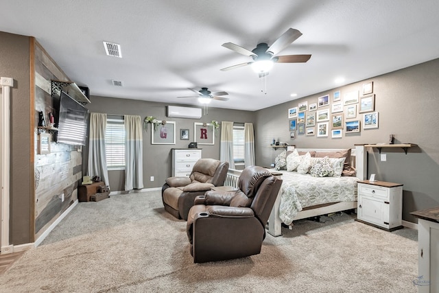 carpeted bedroom with a textured ceiling, an AC wall unit, multiple windows, and ceiling fan