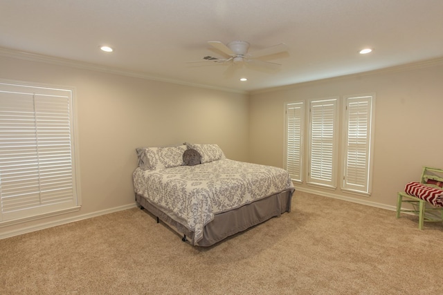 carpeted bedroom with ornamental molding and ceiling fan