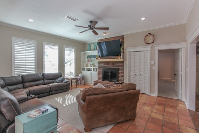 living room featuring tile patterned flooring, crown molding, a fireplace, and ceiling fan