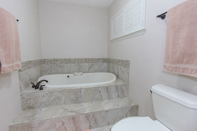 bathroom with a relaxing tiled tub and toilet