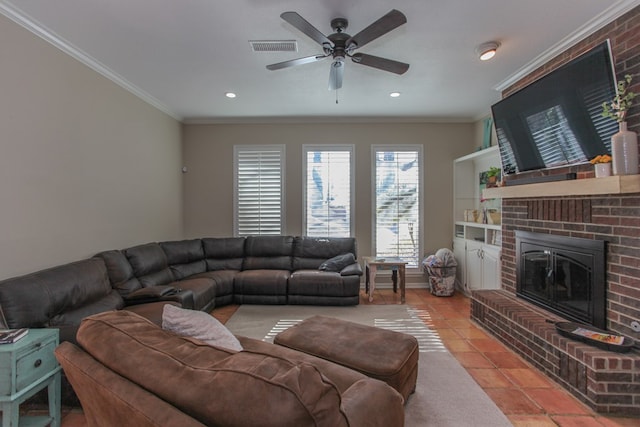 tiled living room with a fireplace, ornamental molding, and ceiling fan