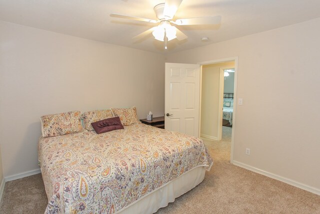 bedroom featuring ceiling fan and carpet