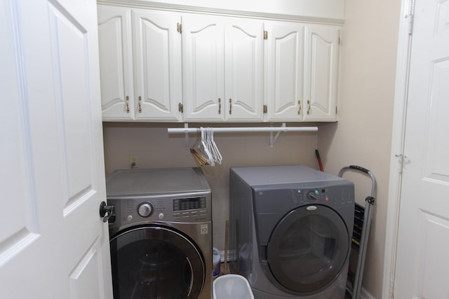 laundry room featuring cabinets and washer and dryer