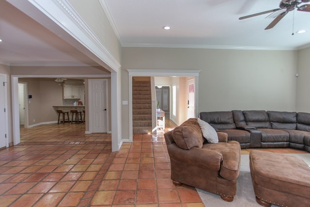 living room with ceiling fan and ornamental molding