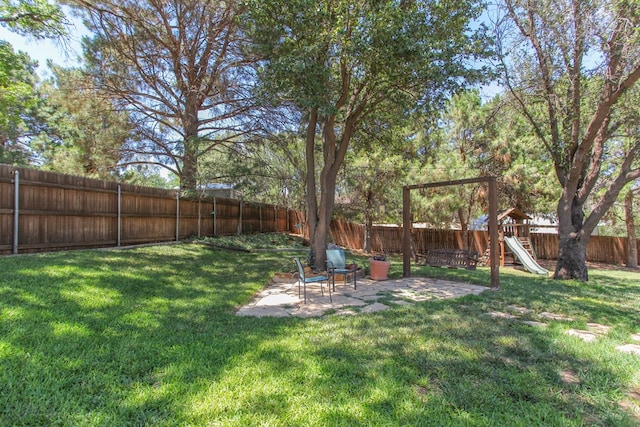 view of yard featuring a playground and a patio area