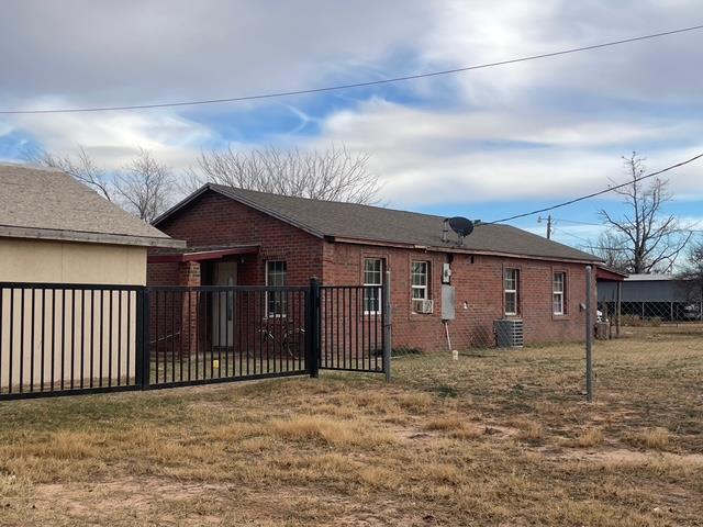 view of property exterior with a lawn