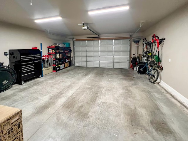 garage with baseboards and a garage door opener