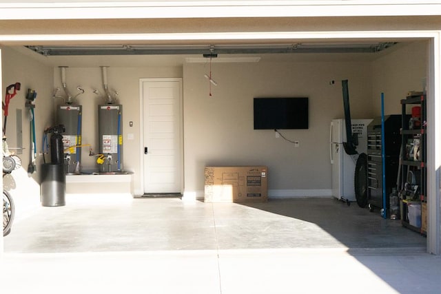 garage with freestanding refrigerator and water heater