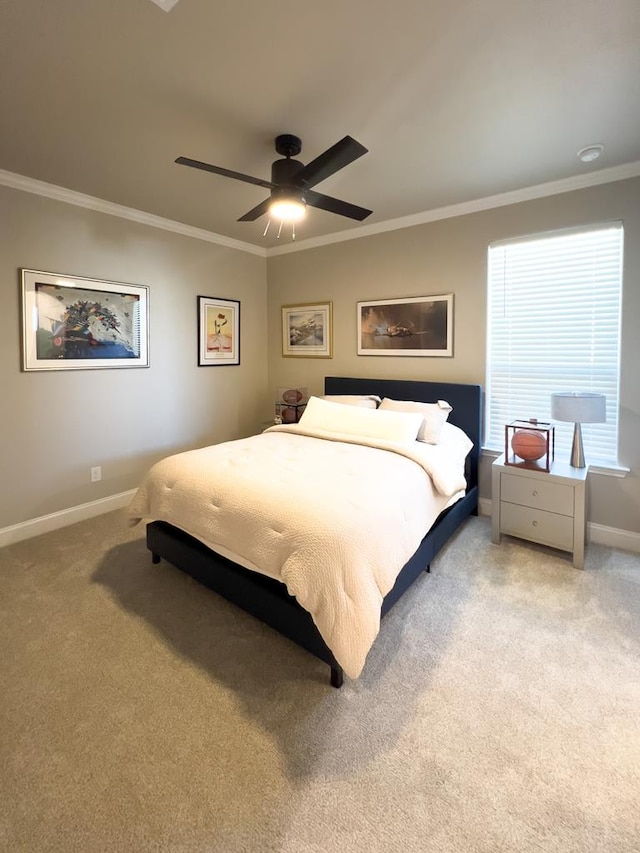 bedroom featuring baseboards, carpet floors, ceiling fan, and crown molding