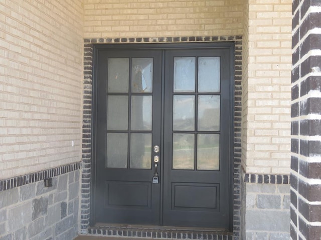 view of exterior entry featuring french doors