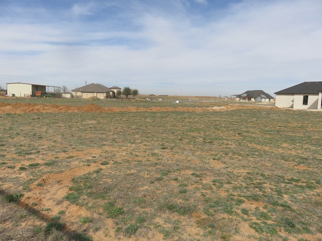 view of yard with a rural view