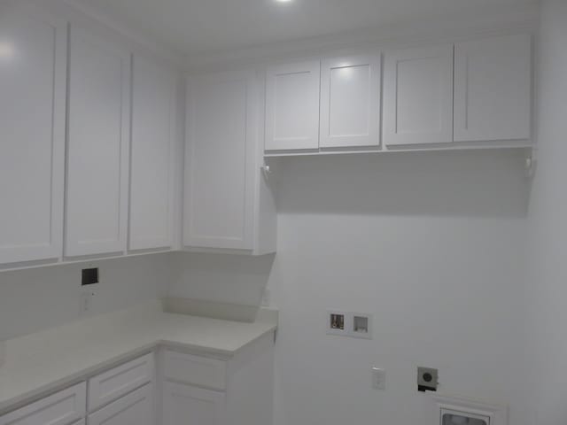 washroom featuring cabinets, hookup for a washing machine, and hookup for an electric dryer