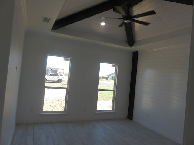 empty room featuring ceiling fan, light wood-type flooring, and a wealth of natural light