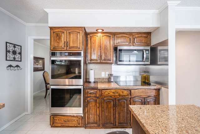 kitchen with stainless steel appliances, tasteful backsplash, crown molding, and a textured ceiling