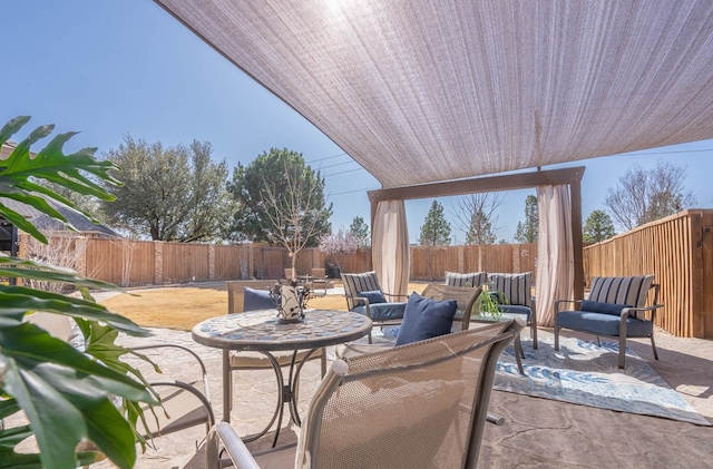 view of patio featuring a fenced backyard and outdoor lounge area