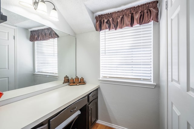 bathroom with vanity and a textured ceiling