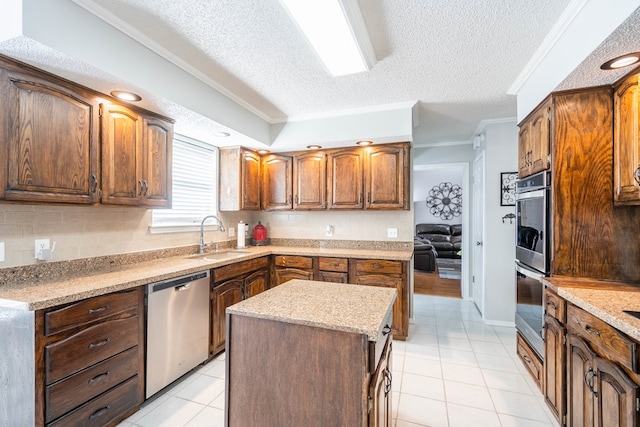 kitchen featuring a sink, appliances with stainless steel finishes, crown molding, and light tile patterned floors