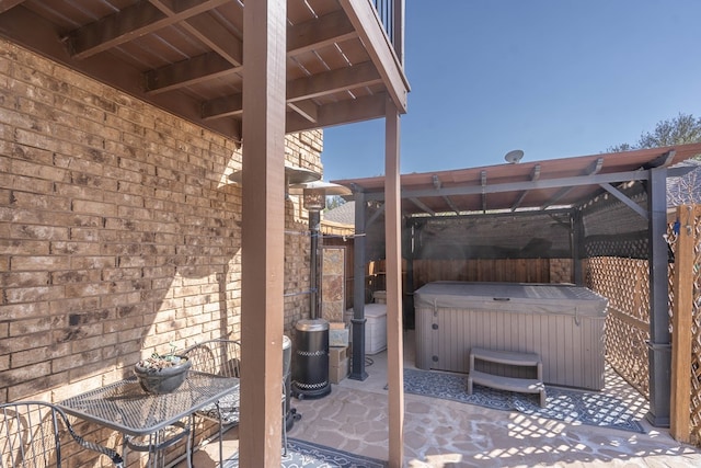 view of patio / terrace with a hot tub