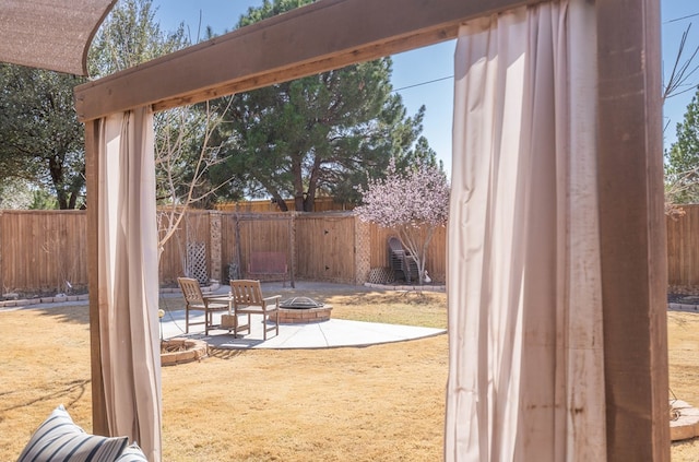 exterior space featuring a patio, a fenced backyard, and an outdoor fire pit