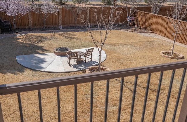 view of yard with a patio area, a fire pit, and a fenced backyard