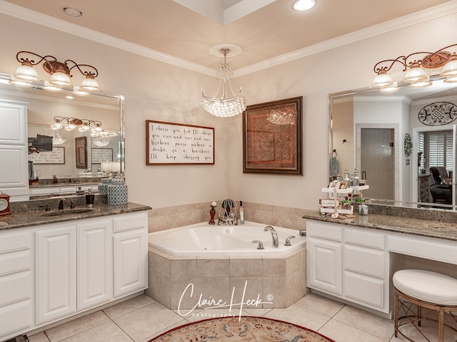 bathroom featuring tile patterned flooring, crown molding, tiled tub, and vanity