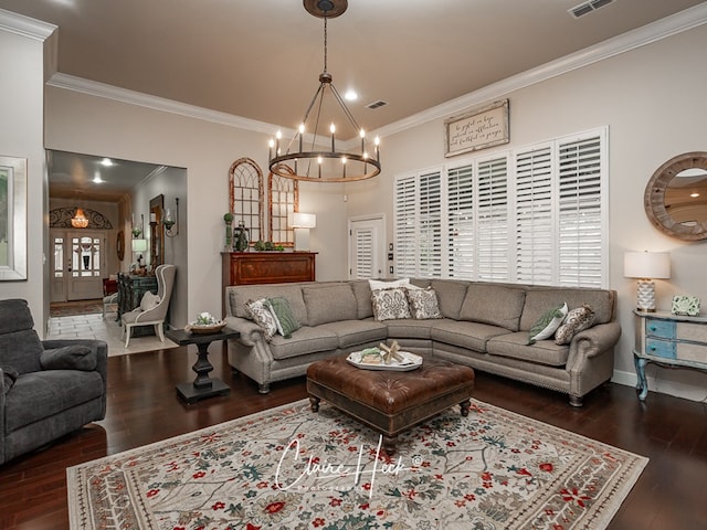 living room featuring crown molding, dark hardwood / wood-style flooring, a chandelier, and french doors